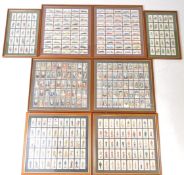 A LARGE COLLECTION OF FRAMED AND GLAZED VINTAGE 2OTH CENTURY CIGARETTE CARDS