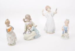 LLADRO, SPAIN - THREE HAND PAINTED PORCELAIN FIGURES T/W ANOTHER