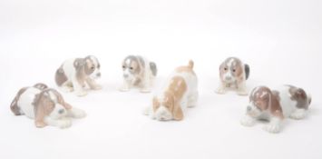 LLADRO & NAO BY LLADRO - SIX HAND PAINTED PORCELAIN DOG FIGURES