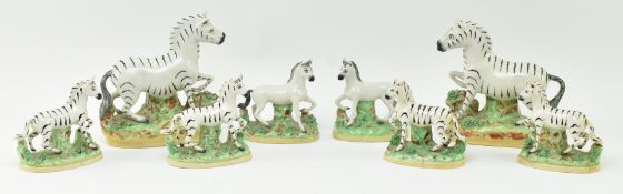 EIGHT 19TH CENTURY STAFFORDSHIRE HAND PAINTED POTTERY ZEBRAS