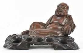 REPUBLICAN WOODEN CARVED FIGURINE OF A BUDDHA 民国实刻卧佛连座