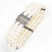 A SILVER THREE STRAND PEARL BRACELET WITH MARCASITE CLASP