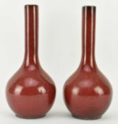 PAIR OF QING DYNASTY FLAMBE SANG DE BOEUF BOTTLE VASES 清 窑变釉长颈瓶一对