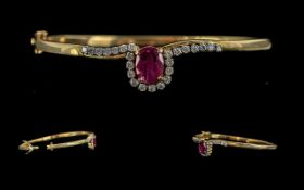 Ladies Pleasing Quality 9ct Gold Diamond and Ruby Set Hinged Bangle, marked 9ct, the centre ruby