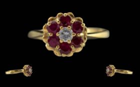 Ladies 18ct Gold Pleasing Ruby & Diamond Set Dress Ring. Flowerhead design, marked 750 to interior