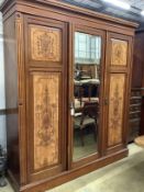 A late Victorian aesthetic movement mahogany and satin birch compactum wardrobe, width 186cm,