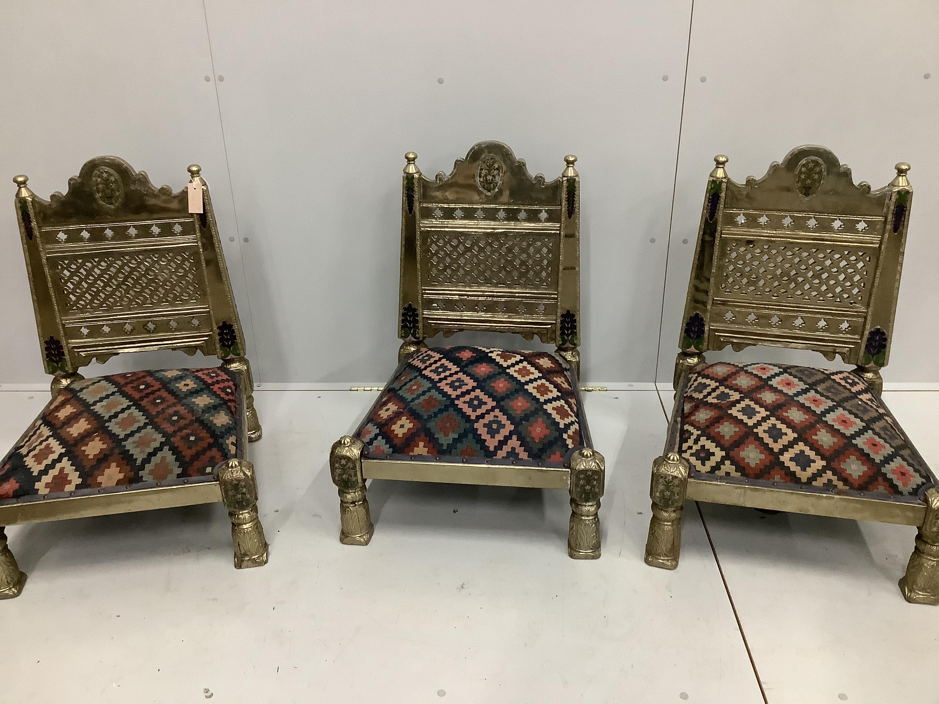 Three Indian metal clad Pidha low chairs with enamelled decoration and Kilim covered seats, width