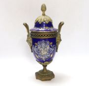 A Limoges style porcelain ormolu mounted urn and cover, 29cm high