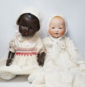 A Black Dream Baby AM351 bisque head bent limb body, 60cm and a Dream Baby AM351 with celluloid