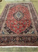 A Kashan red ground carpet, 308 x 190cm
