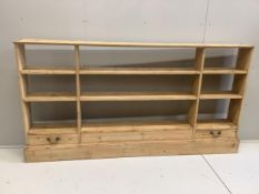 A Victorian style pine two drawer open bookcase, width 220cm, width 25cm, height 114cm