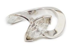 A modern 18ct white gold and solitaire marquise cut diamond set ring, with crossover shoulders,