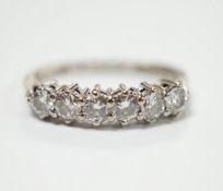 A modern 18ct white gold and six stone diamond set half hoop ring, (shank slightly crushed), gross