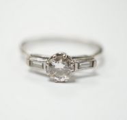 A white metal and single stone diamond set ring, with two stone baguette cut diamond set
