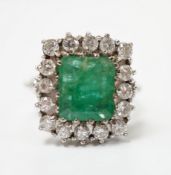 A white metal, emerald and diamond set square cluster ring, size I, gross weight 6.3 grams.