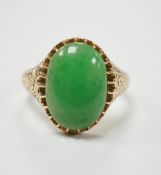 A yellow metal (stamped 18) and single stone cabochon jade set ring, size Q, gross weight 5.7
