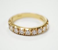 A modern 18ct gold and nine stone diamond set half hoop ring, size R/S, gross weight 6 grams.