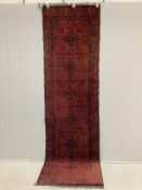 An Afghan red ground runner, 290 x 85cm