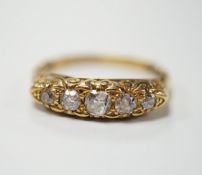 An Edwardian 18ct gold and graduated five stone diamond set half hoop ring. size R, gross weight 4.4