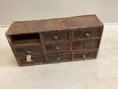 A painted pine nest of eight drawers, width 78cm, depth 22cm, height 38cm