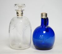 A silver mounted wheel engraved glass decanter and stopper and a white metal mounted Bristol blue