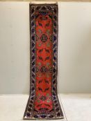 A Turkish red ground runner, 330 x 74cm