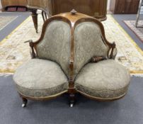 A late Victorian amboyna banded walnut conversation seat, (one leg detached), width 140cm, height