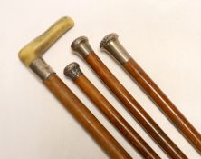 Four silver topped walking canes, one with antler handle