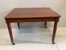 An early Victorian rectangular mahogany table, raised on fluted legs and brass castors, width 111cm,