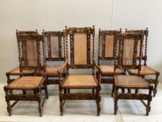 A set of seven Jacobean Revival caned oak dining chairs, one with arms
