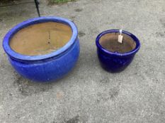 Two circular blue glazed earthenware garden planters, with detachable feet, largest diameter 51cm,