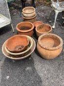 Ten assorted terracotta garden planters and three dish stands, largest diameter 32cm, height 30cm