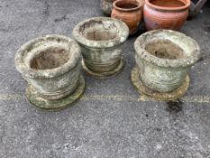 A set of three circular reconstituted stone garden planters with dished bases, diameter 43cm, height