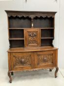An early 20th century Flemish carved oak bow front dresser, width 138cm, depth 50cm, height