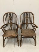 A pair of ash and elm Windsor wheel back armchairs, width 58cm, depth 48cm, height 112cm***CONDITION
