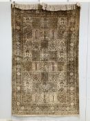A Kashmir ‘silk’ rug, woven all over with rectangles filled with stylised flowers, 220 x 138cm***