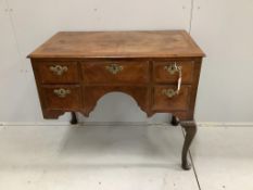 A Queen Anne Revival feather banded walnut kneehole dressing table (front leg a/f), width 88cm,