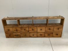 A Victorian pine bank of fourteen drawers, width 183cm, depth 21cm, height 66cm***CONDITION