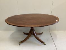 A George III and later satinwood banded oval mahogany tilt top dining table, width 152cm, depth