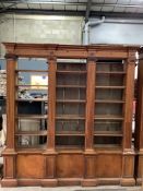 A pair of mid 20th century Sheraton style pitch pine and ply open bookcases, the adjustable