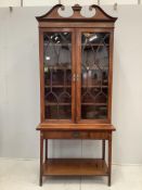 A George III and later two door mahogany bookcase on stand, width 98cm, depth 33cm, height 217cm***