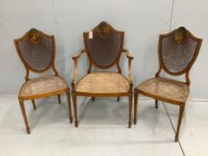 A set of three Edwardian Sheraton Revival painted satinwood caned chairs, one with arms***