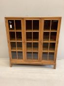 An early 20th century Heal & Son, London glazed walnut three door bookcase, width 122cm, depth 29cm,