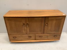 An Ercol Windsor elm sideboard, width 130cm, depth 47cm, height 76cm