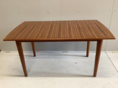 A mid century Gordon Russell teak dining suite comprising rectangular extending table, twelve chairs