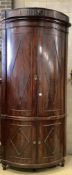 An unusually tall late 18th century Dutch mahogany bow fronted corner cabinet, in two sections,
