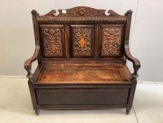 A late Victorian oak box seat settle, width 107cm, depth 44cm, height 109cm. Condition - fair