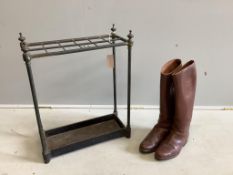 An early 20th century tubular brass and cast iron twelve division stick stand, width 50cm, height
