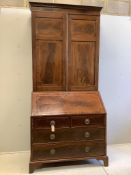 A late Georgian mahogany bureau bookcase crossbanded and inlaid upper section, fitted a pair of
