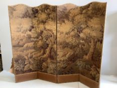 An Edwardian four fold draught screen, covered with a Brussels machine made woodland scene, each